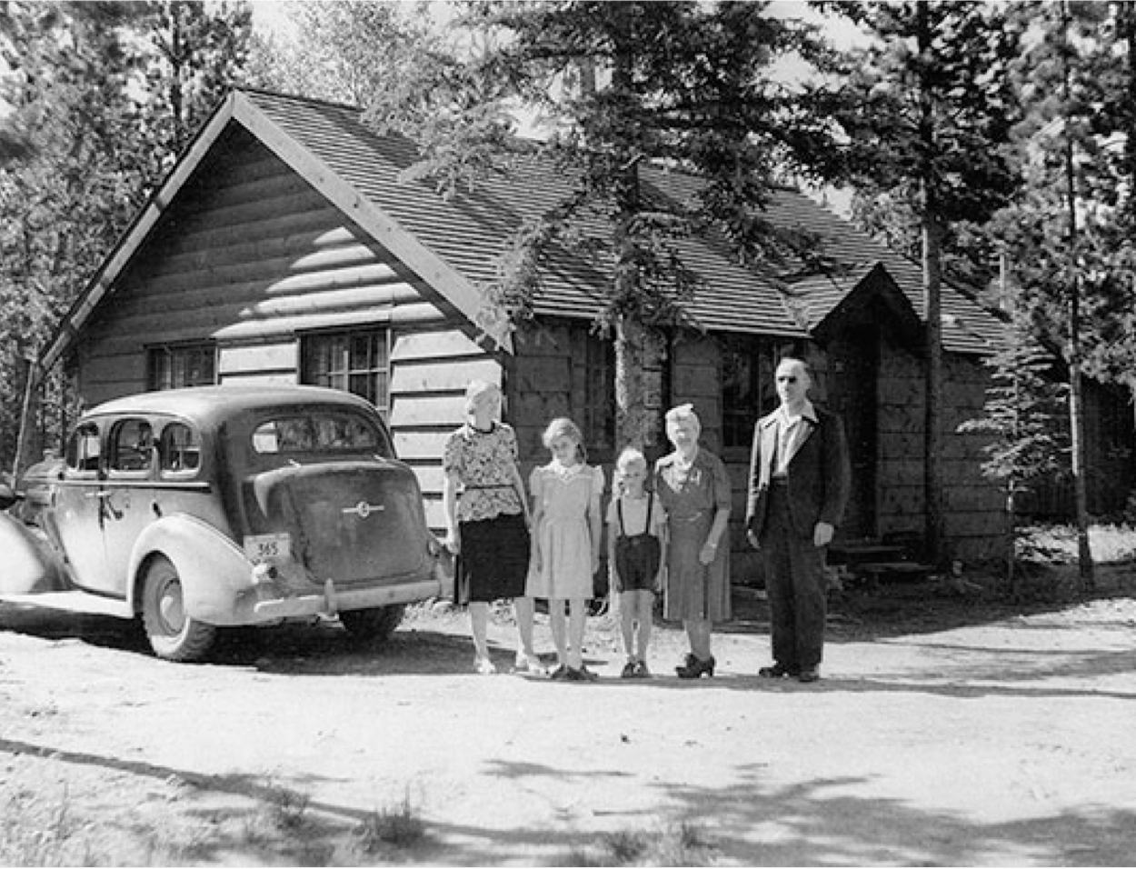 A family stands for a photo in 1956 in front of a Jasper Cabin rental